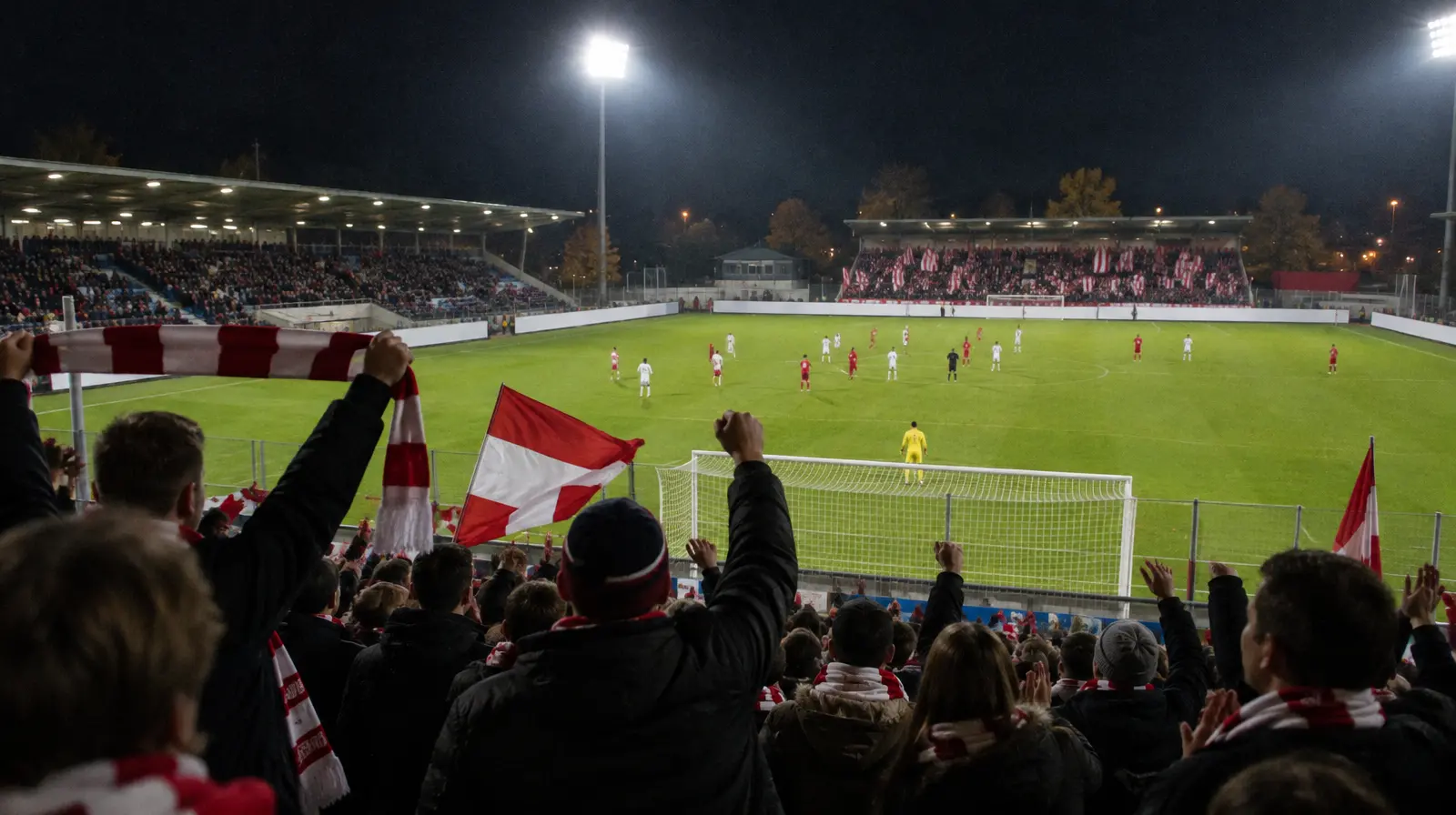 Hemmafans jublar på läktaren i kvällsljus